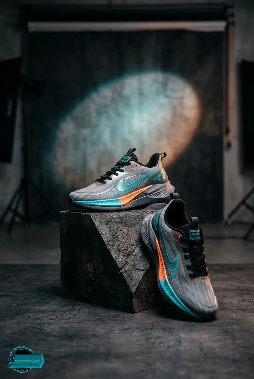 Mesmerizee dark grey premium running mesh sneakers for men on a stone pedestal.