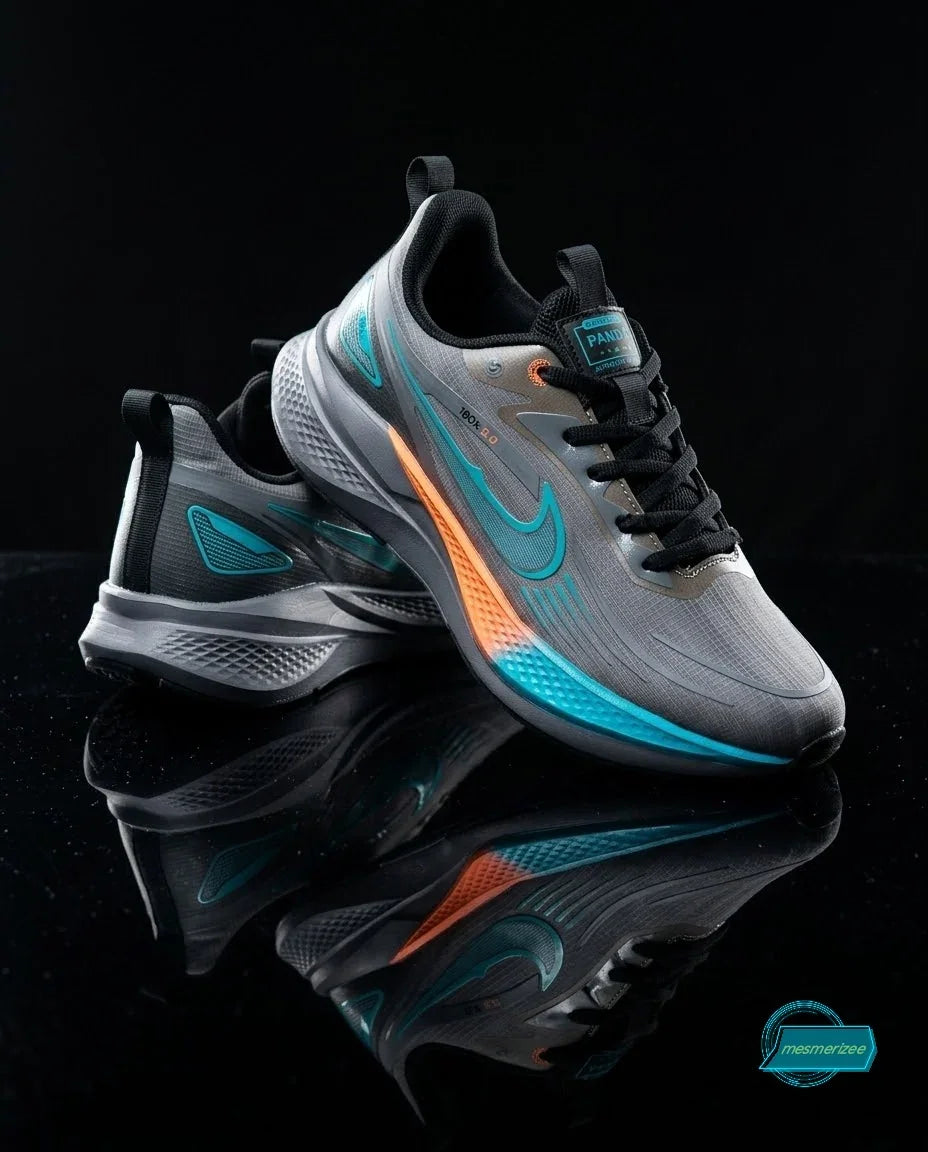 Grey athletic sneakers with turquoise and orange accents on a reflective black surface