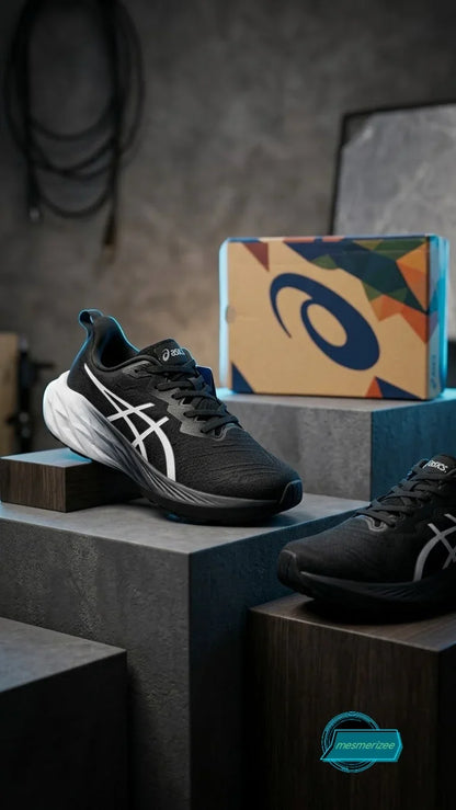 Asics black premium running mesh sneakers for men displayed on pedestals with product box.
