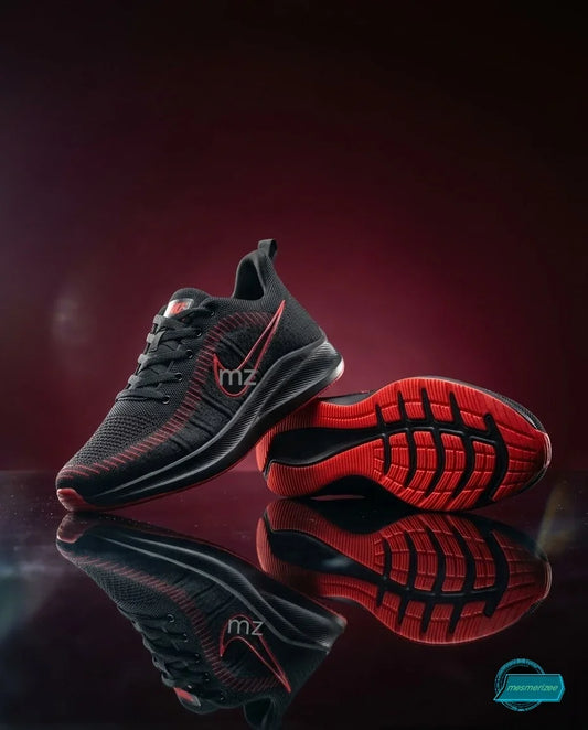 Black Mesmerizee premium running mesh sneakers for men with red sole accents.
